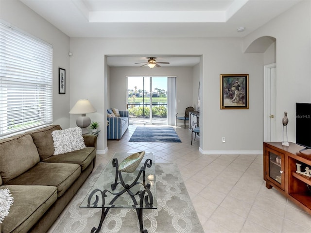 165 Tiziano Way N, Venice, FL 34275 - living room with a raised ceiling, light tile patterned floors, arched walkways, and a ceiling fan