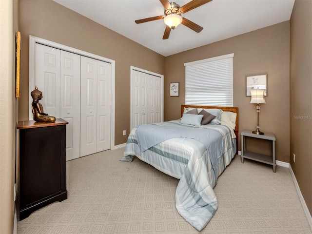 165 Tiziano Way N, Venice, FL 34275 - bedroom with multiple closets, baseboards, light carpet, and ceiling fan
