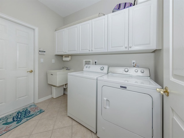 165 Tiziano Way N, Venice, FL 34275 - laundry room featuring cabinet space, washing machine and clothes dryer, light tile patterned floors, and baseboards