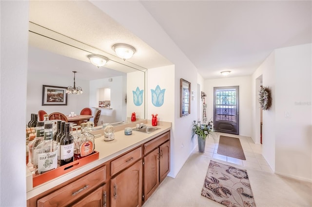 410 Mission Trl E Unit B, Venice, FL 34285 - bathroom with a chandelier, vanity, baseboards, and tile patterned flooring
