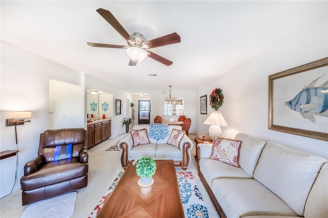 410 Mission Trl E Unit B, Venice, FL 34285 - living area featuring light colored carpet, a ceiling fan, and a chandelier