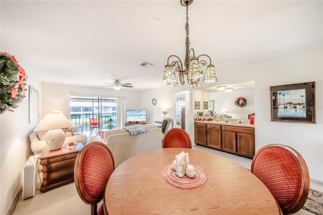 410 Mission Trl E Unit B, Venice, FL 34285 - dining area featuring a chandelier, ceiling fan, and light carpet