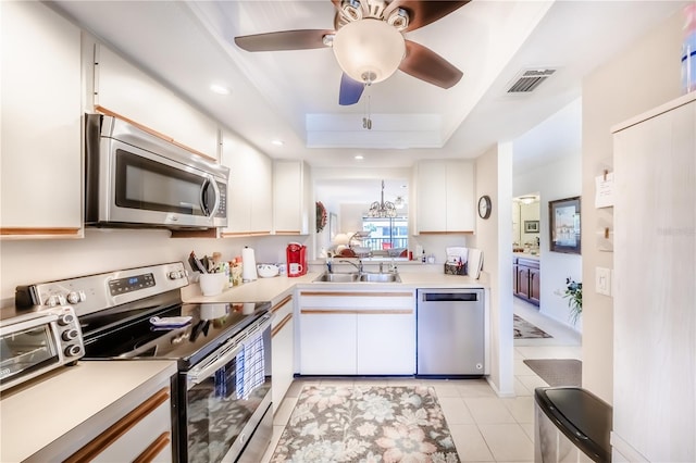 410 Mission Trl E Unit B, Venice, FL 34285 - kitchen featuring stainless steel appliances, a sink, light countertops, white cabinets, and light tile patterned floors
