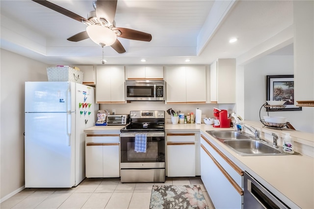 410 Mission Trl E Unit B, Venice, FL 34285 - kitchen featuring appliances with stainless steel finishes, a raised ceiling, a sink, light countertops, and recessed lighting