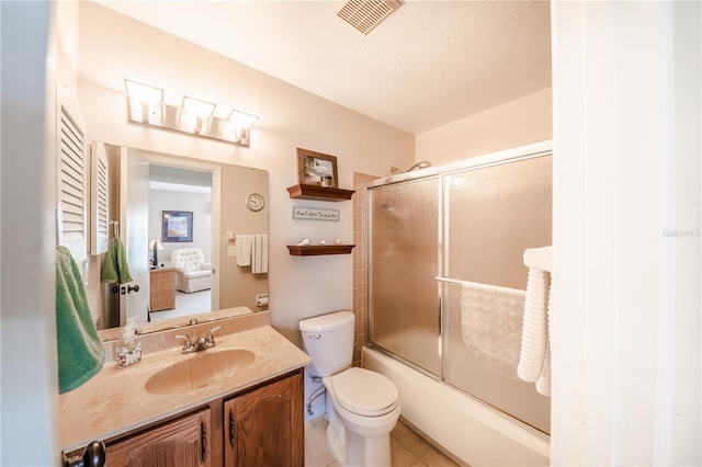 410 Mission Trl E Unit B, Venice, FL 34285 - bathroom with vanity, toilet, shower / bath combination with glass door, and tile patterned flooring