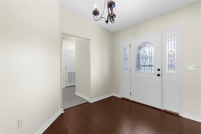4305 Heyward St, North Port, FL 34291 - foyer entrance featuring a chandelier, dark wood-style flooring, and baseboards
