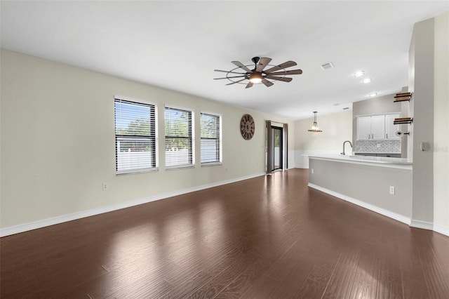 4305 Heyward St, North Port, FL 34291 - unfurnished living room with a ceiling fan, dark wood-style floors, a sink, baseboards, and recessed lighting
