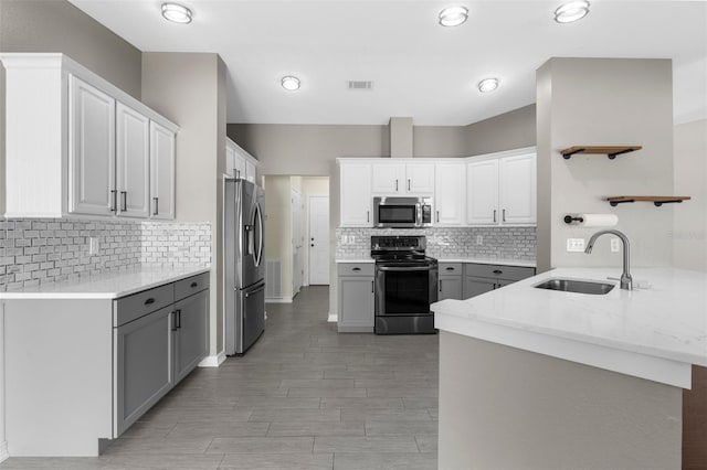 4305 Heyward St, North Port, FL 34291 - kitchen featuring stainless steel appliances, a sink, a peninsula, decorative backsplash, and recessed lighting