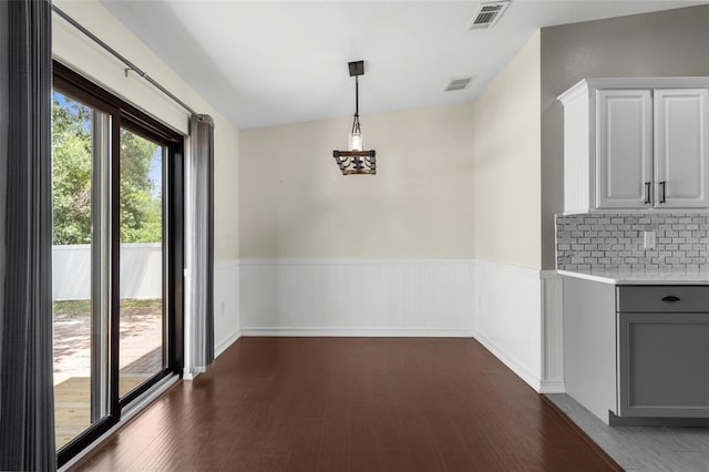 4305 Heyward St, North Port, FL 34291 - unfurnished dining area with dark wood-style floors and wainscoting