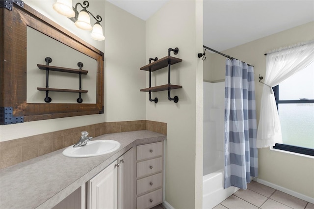 4305 Heyward St, North Port, FL 34291 - bathroom featuring vanity, shower / tub combo with curtain, tile patterned floors, and baseboards