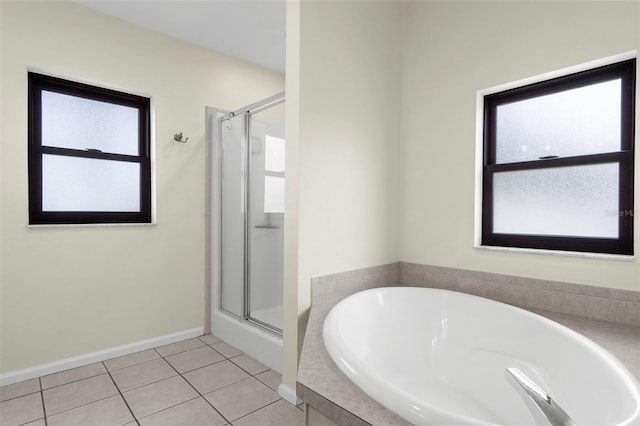 4305 Heyward St, North Port, FL 34291 - full bathroom featuring a garden tub, a shower stall, tile patterned floors, and baseboards