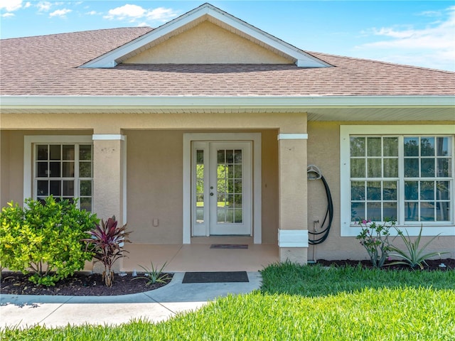 6199 Stamp St, Port Charlotte, FL 33981 - doorway to property with roof with shingles, stucco siding, and a porch