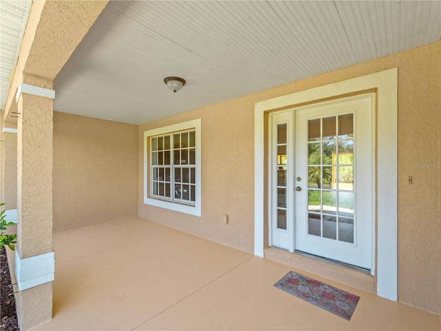 6199 Stamp St, Port Charlotte, FL 33981 - property entrance with stucco siding and a patio