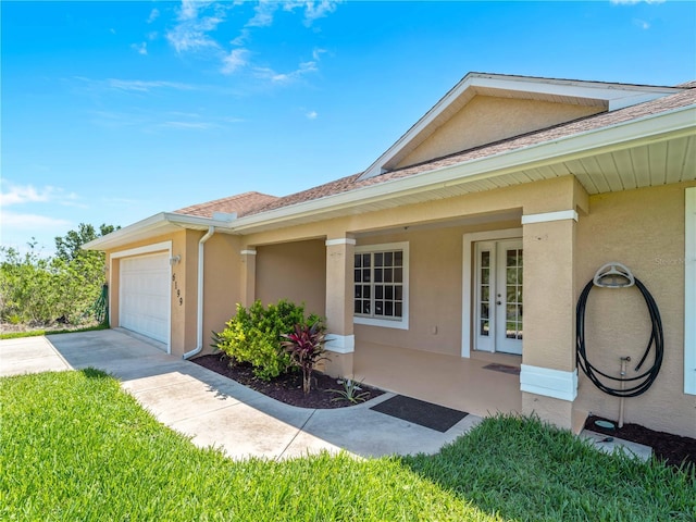 6199 Stamp St, Port Charlotte, FL 33981 - view of front of property featuring stucco siding, a garage, concrete driveway, and french doors