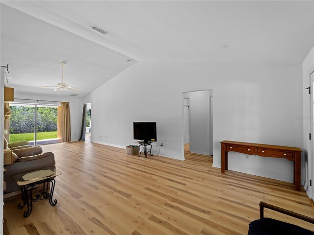6199 Stamp St, Port Charlotte, FL 33981 - living area featuring lofted ceiling, light wood-style floors, ceiling fan, and baseboards