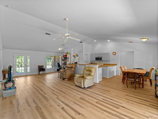 6199 Stamp St, Port Charlotte, FL 33981 - living area featuring vaulted ceiling, light wood-style floors, and a ceiling fan