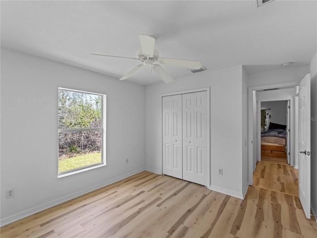 6199 Stamp St, Port Charlotte, FL 33981 - unfurnished bedroom featuring light wood-style floors, a closet, baseboards, and ceiling fan