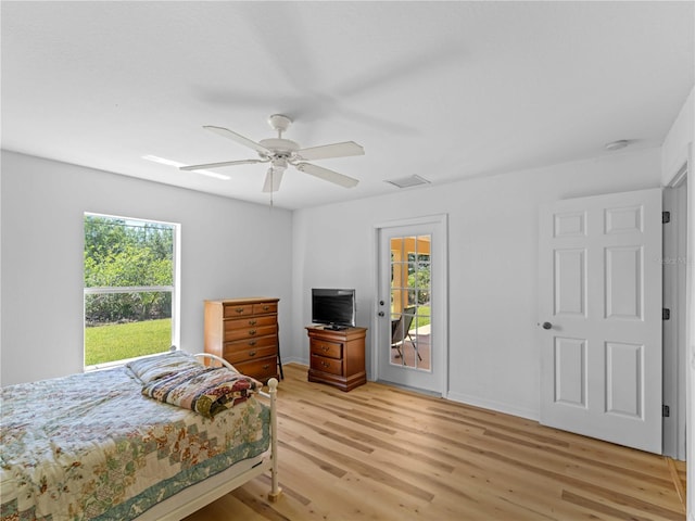 6199 Stamp St, Port Charlotte, FL 33981 - bedroom with multiple windows, light wood-style flooring, access to exterior, and a ceiling fan