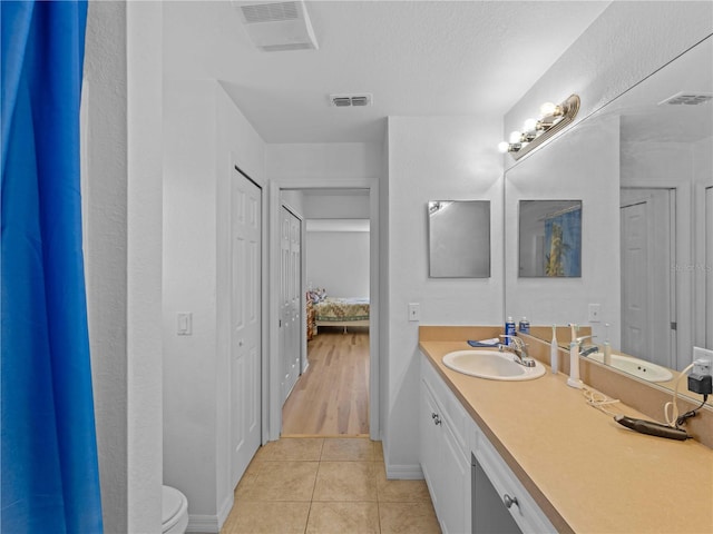 6199 Stamp St, Port Charlotte, FL 33981 - bathroom with baseboards, tile patterned flooring, vanity, toilet, and ensuite bath