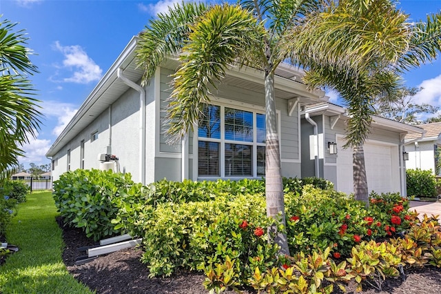 629 Ibiza Loop, Venice, FL 34292 - view of side of home with a garage and stucco siding