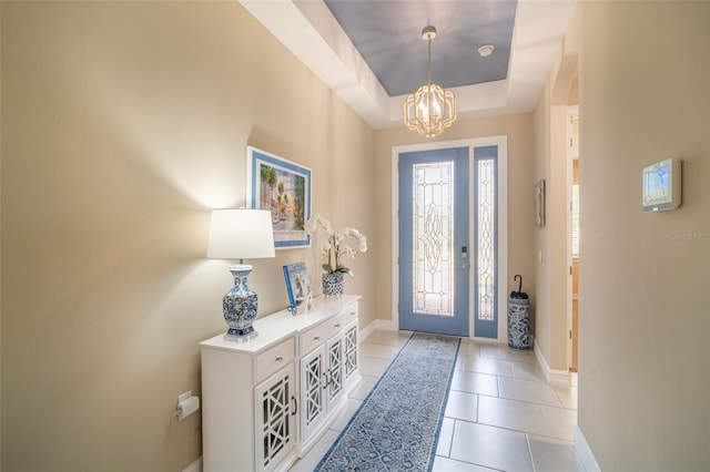 629 Ibiza Loop, Venice, FL 34292 - foyer entrance with a chandelier, baseboards, light tile patterned flooring, and a raised ceiling