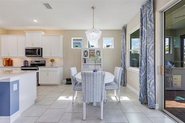 629 Ibiza Loop, Venice, FL 34292 - dining area featuring a chandelier, light tile patterned floors, recessed lighting, and baseboards
