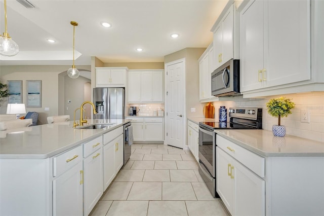 629 Ibiza Loop, Venice, FL 34292 - kitchen featuring stainless steel appliances, a sink, tasteful backsplash, recessed lighting, and white cabinets