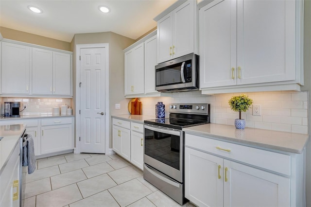 629 Ibiza Loop, Venice, FL 34292 - kitchen featuring stainless steel appliances, white cabinetry, light countertops, backsplash, and recessed lighting