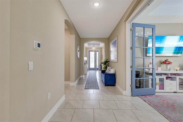 629 Ibiza Loop, Venice, FL 34292 - entryway with arched walkways, baseboards, and light tile patterned floors