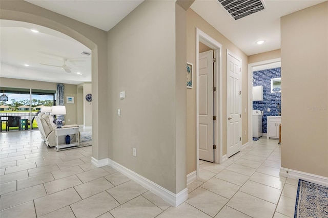 629 Ibiza Loop, Venice, FL 34292 - hall with light tile patterned floors, recessed lighting, arched walkways, and baseboards