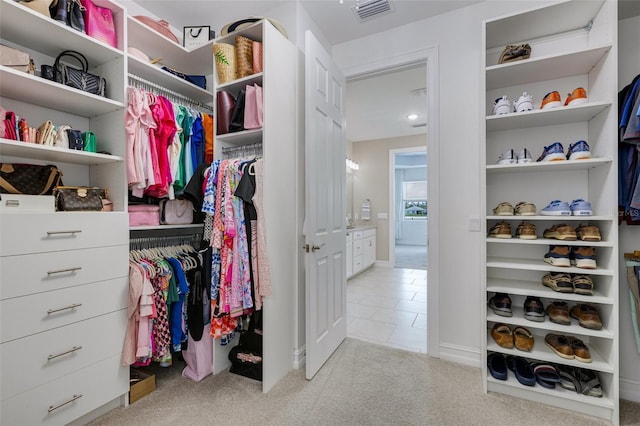 629 Ibiza Loop, Venice, FL 34292 - walk in closet featuring carpet floors and tile patterned flooring