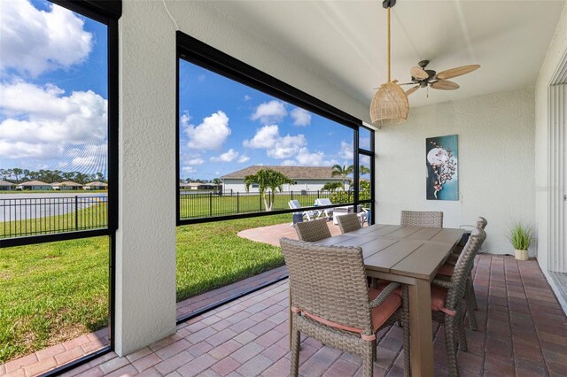 629 Ibiza Loop, Venice, FL 34292 - sunroom / solarium featuring a ceiling fan and outdoor dining area