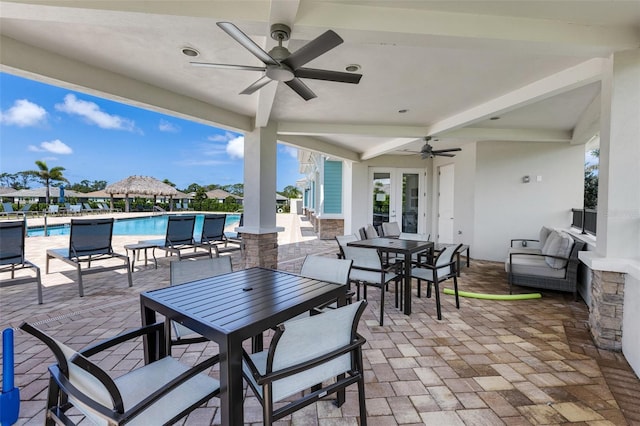 629 Ibiza Loop, Venice, FL 34292 - view of patio featuring outdoor dining space, a ceiling fan, french doors, and a community pool