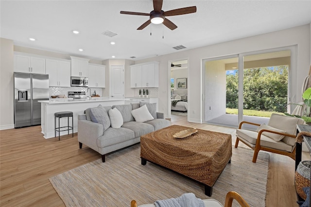 4390 Asteria Ter, North Port, FL 34287 - living room featuring a ceiling fan, light wood-style floors, and recessed lighting