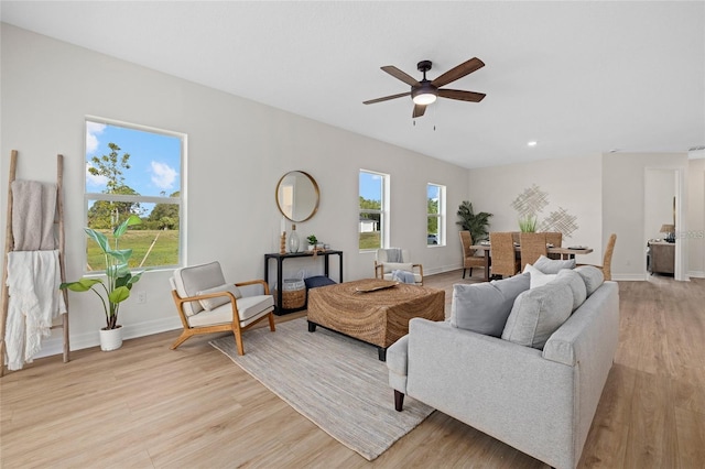 4390 Asteria Ter, North Port, FL 34287 - living room featuring light wood-style flooring, a ceiling fan, and baseboards