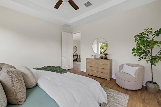 4390 Asteria Ter, North Port, FL 34287 - bedroom featuring wood finished floors, baseboards, ceiling fan, and a tray ceiling