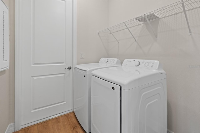 4390 Asteria Ter, North Port, FL 34287 - clothes washing area featuring washing machine and dryer and light wood-type flooring