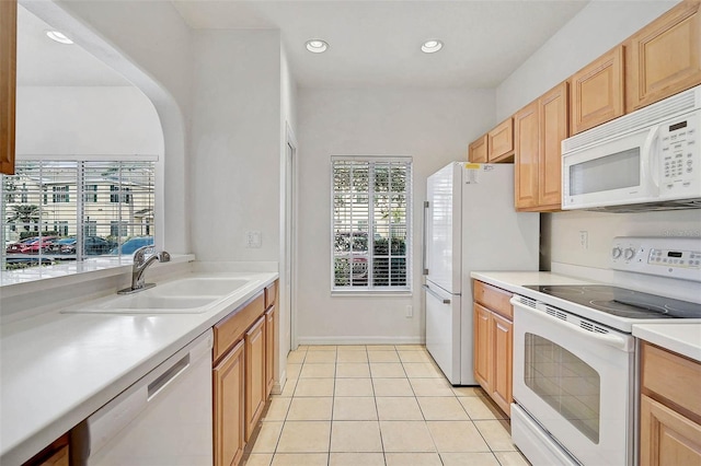 kitchen featuring white appliances, a sink, light countertops, light tile patterned floors, and recessed lighting