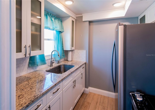 1255 Tarpon Center Dr Unit 604, Venice, FL 34285 - kitchen with a sink, freestanding refrigerator, and white cabinets