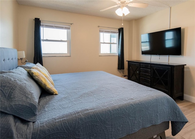 1255 Tarpon Center Dr Unit 604, Venice, FL 34285 - bedroom with wood finished floors, a ceiling fan, and baseboards