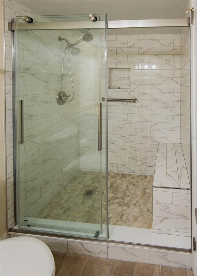 1255 Tarpon Center Dr Unit 604, Venice, FL 34285 - bathroom featuring a shower stall, toilet, and wood finished floors