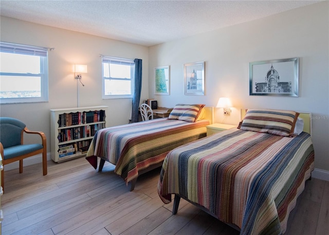 1255 Tarpon Center Dr Unit 604, Venice, FL 34285 - bedroom featuring hardwood / wood-style floors and baseboards