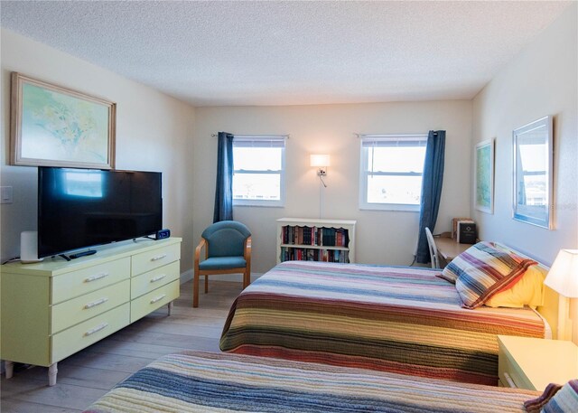 1255 Tarpon Center Dr Unit 604, Venice, FL 34285 - bedroom with wood finished floors and a textured ceiling