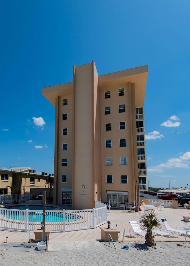 1255 Tarpon Center Dr Unit 604, Venice, FL 34285 - view of building exterior featuring fence and a community pool