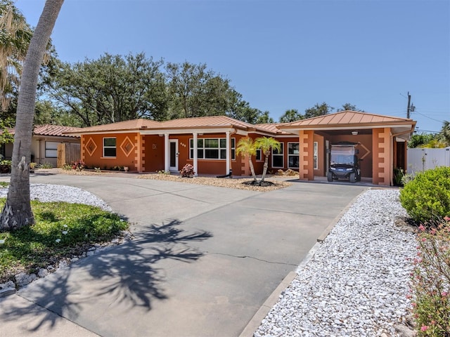 single story home with driveway, a standing seam roof, metal roof, stucco siding, and fence