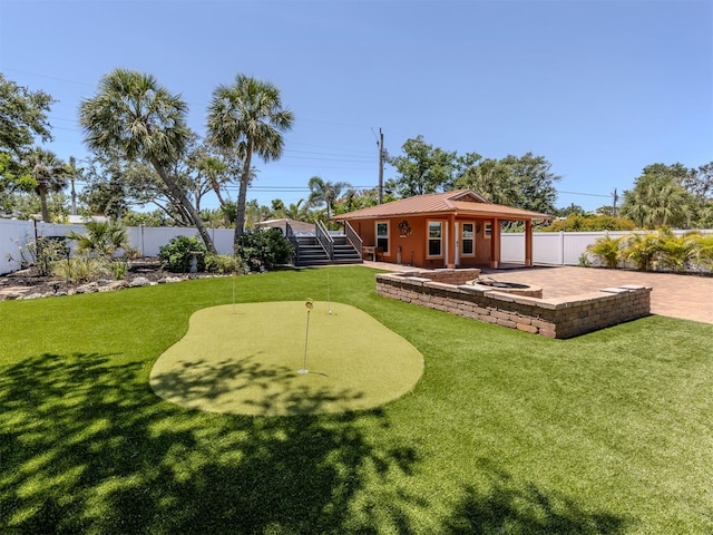 view of yard with a putting green and a patio area