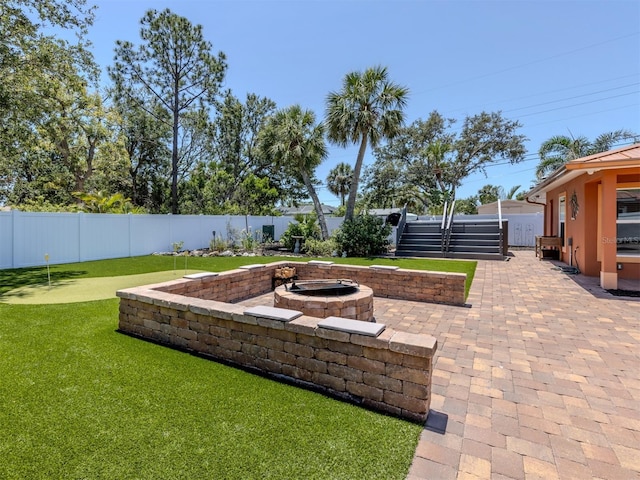 fenced backyard with a fire pit, a patio area, and an area to practice putting