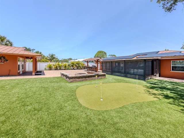 view of yard with an area to practice putting, a patio area, and a sunroom