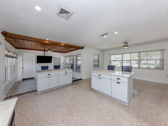 kitchen featuring open floor plan, a center island, plenty of natural light, ceiling fan, and recessed lighting