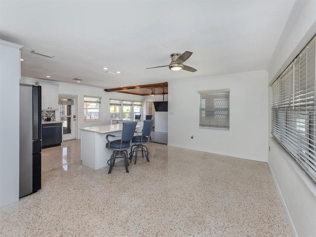 home office featuring recessed lighting, dark speckled floor, crown molding, baseboards, and ceiling fan
